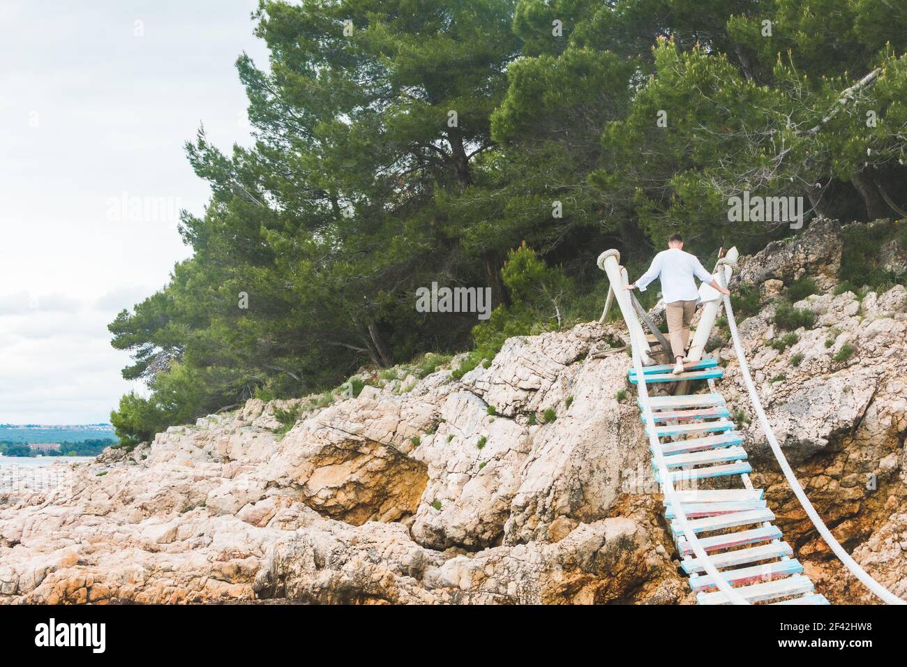 man walking by suspension bridge cross sea famous landmark Stock Photo ...
