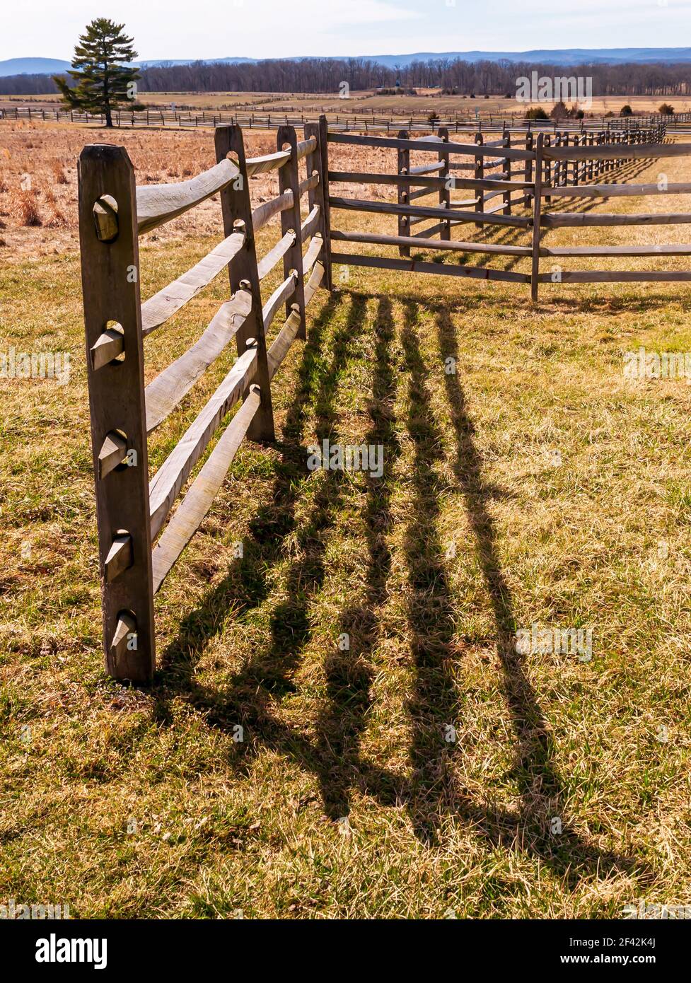 A shadow cast from a wooden fence on the Gettysburg National Military Park on a sunny spring day Stock Photo