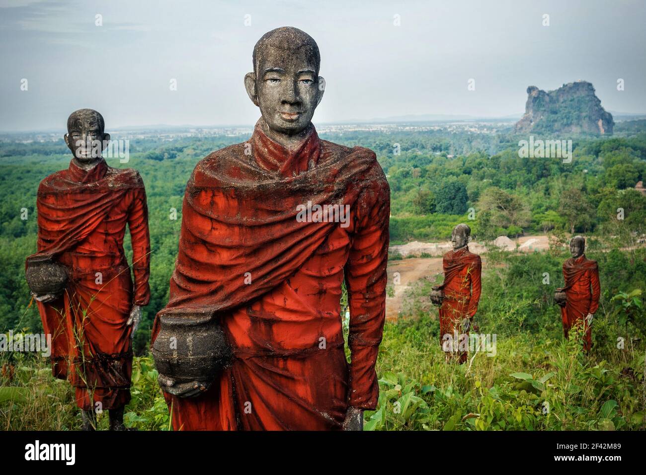 Hundreds of old statues of Buddhist monks collecting alms surround the Win Sein Taw Ya Buddha in Mawlamyine, Myanmar (Burma). Stock Photo