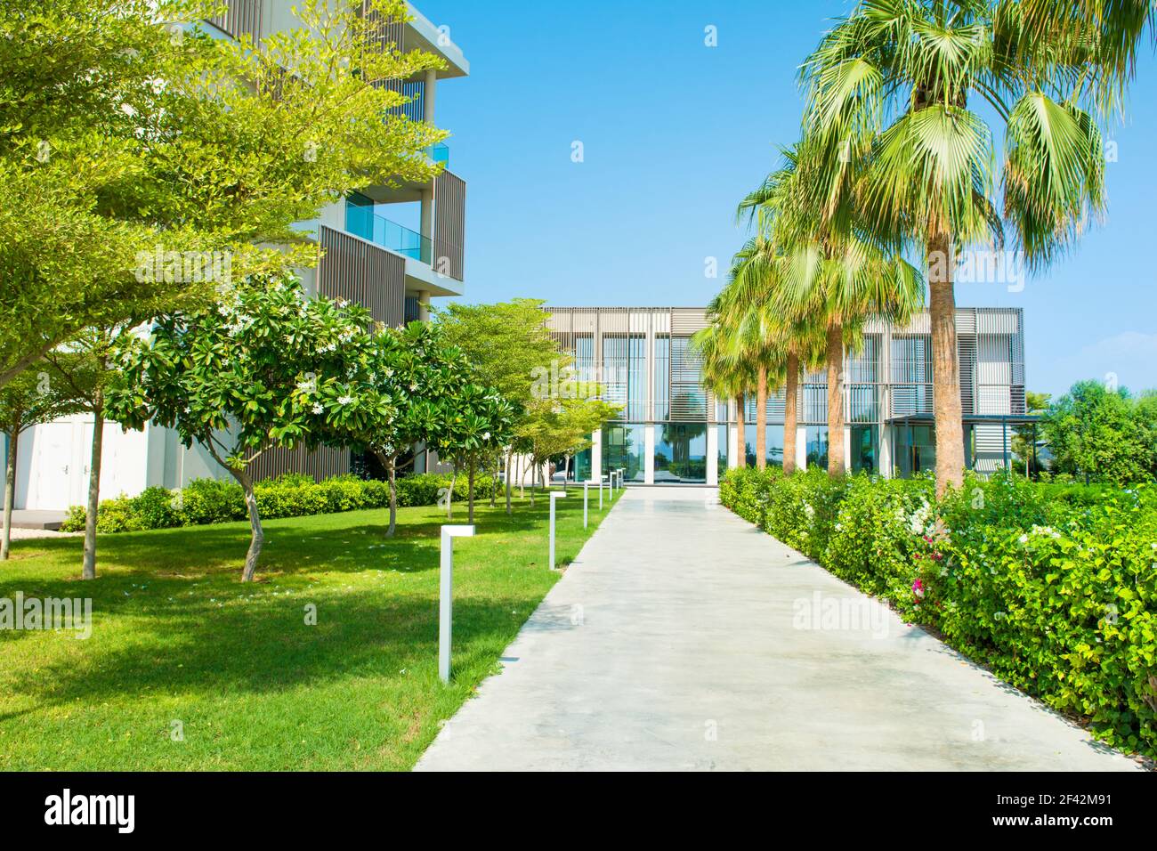 Ajman, United Arab Emirates - 30 October 2018: Landscape with modern design villas and garden in a luxury hotel in Al Zorah coastline Stock Photo