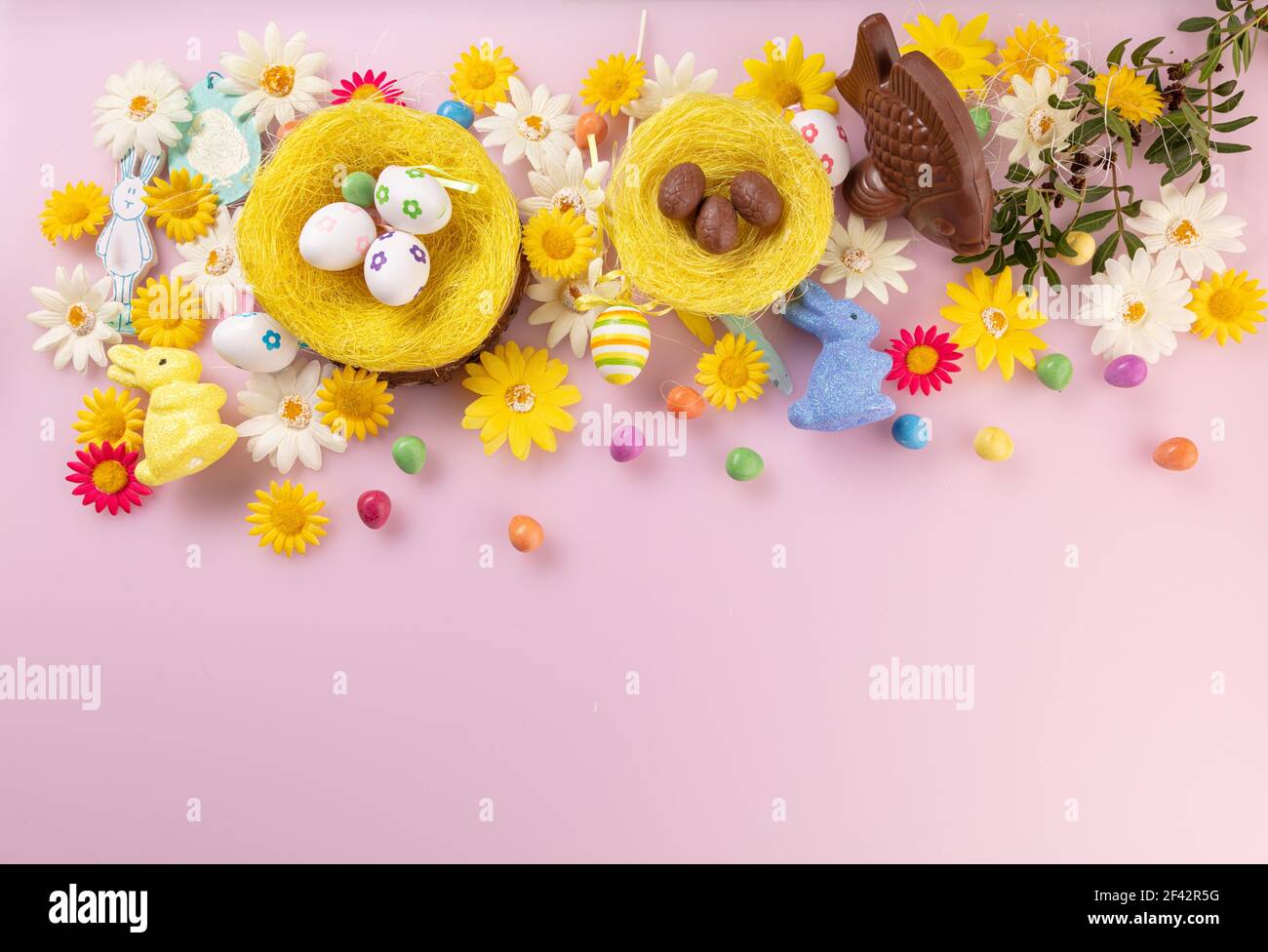 https://c8.alamy.com/comp/2F42R5G/fish-and-milk-chocolate-egg-with-easter-decoration-on-pink-background-seen-from-top-view-with-space-to-write-2F42R5G.jpg