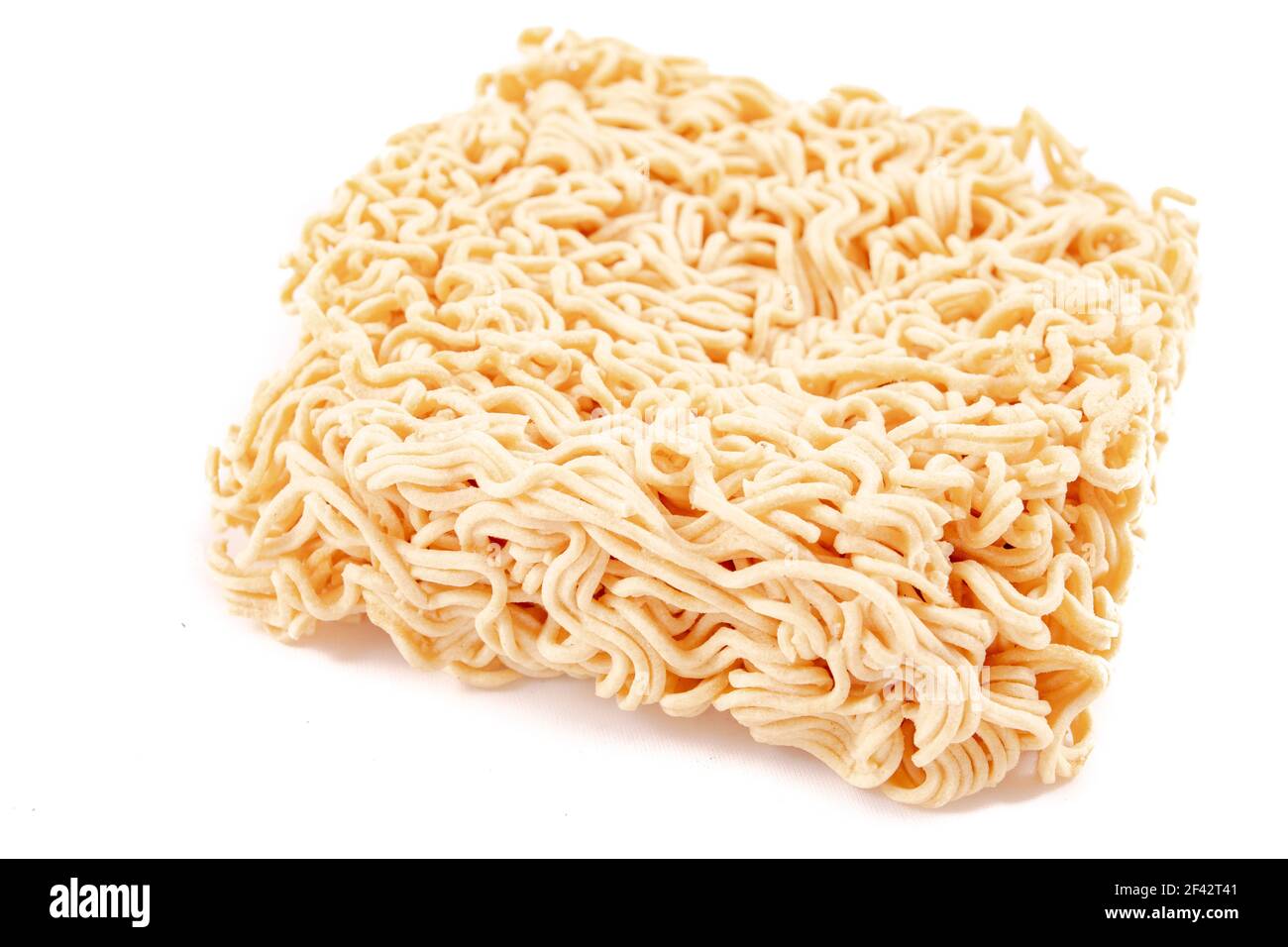 Structure of an instant noodle soup. Dry pasta used in instant dishes. Light background. Stock Photo