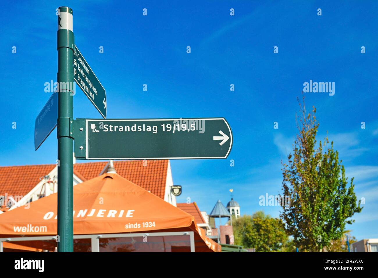 De Koog, Texel, Netherlands - August 2019: Road sign leading to holiday park called 'Strandslag' in front of blue sky Stock Photo