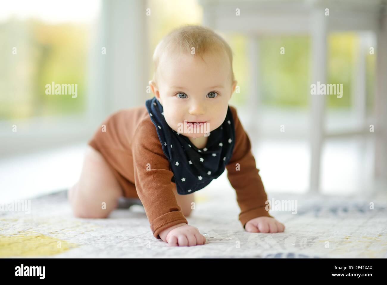 Cute five months old baby boy rocking back and forth on hands and knees