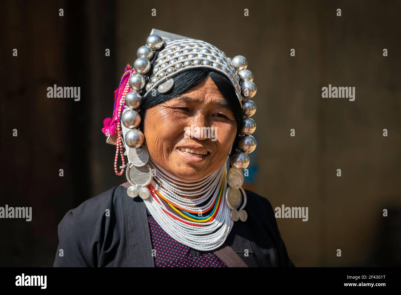 Portrait of smiling adult woman of Akha tribe near Kengtung, Myanmar Stock Photo