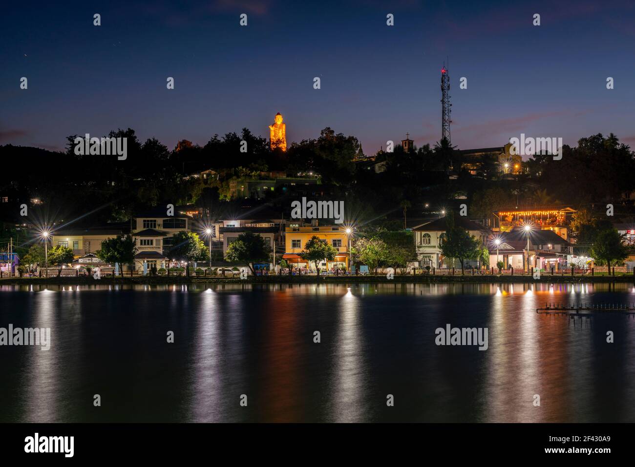 Buddha statue above Nong Tung Lake at night, Kengtung, Myanmar Stock Photo