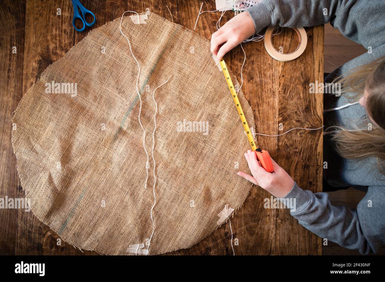 Overhead View of Student Working at Table on School Science Project Stock Photo