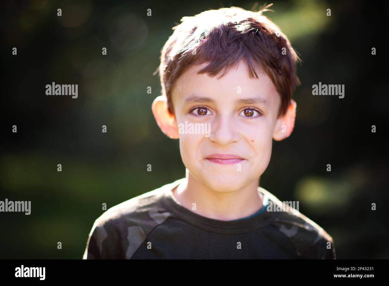 Happy cute little boy with brown eyes outdoors Stock Photo Alamy