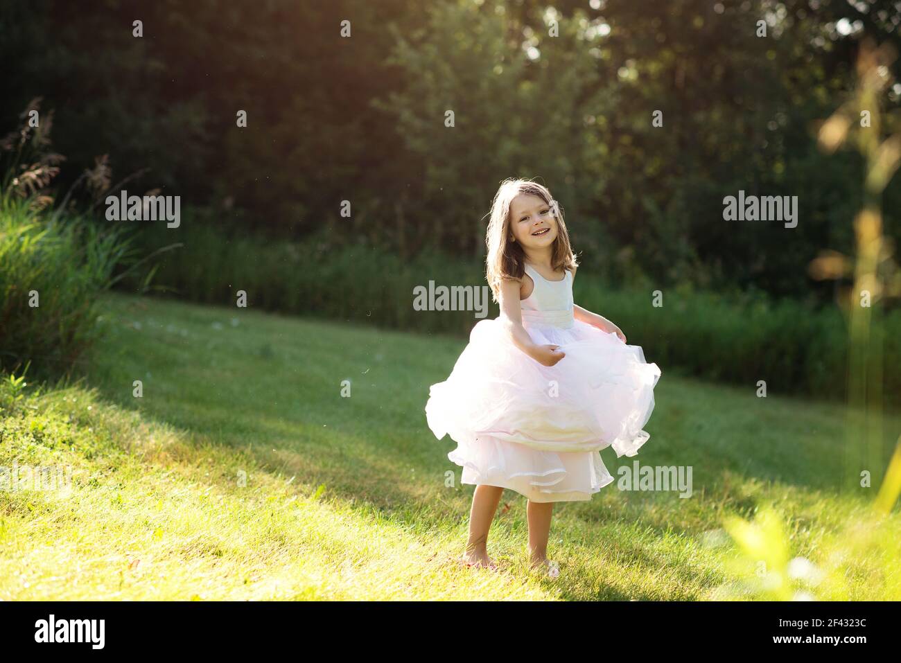 6. Little girl with blond hair and a pink dress twirling - wide 7