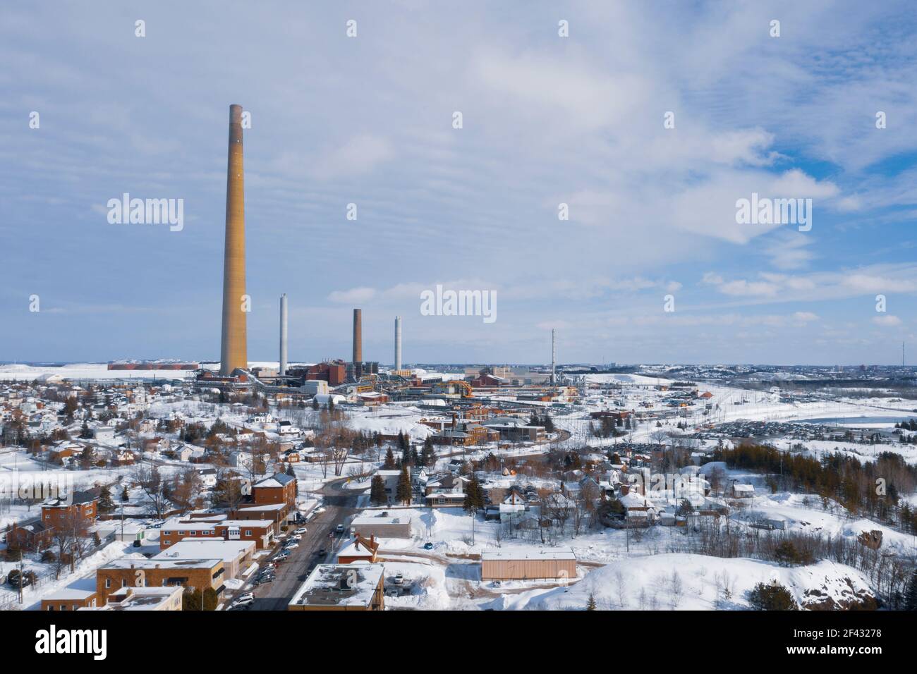 Smoke Stack Rises 1000 Ft. Over Wintery Town Stock Photo