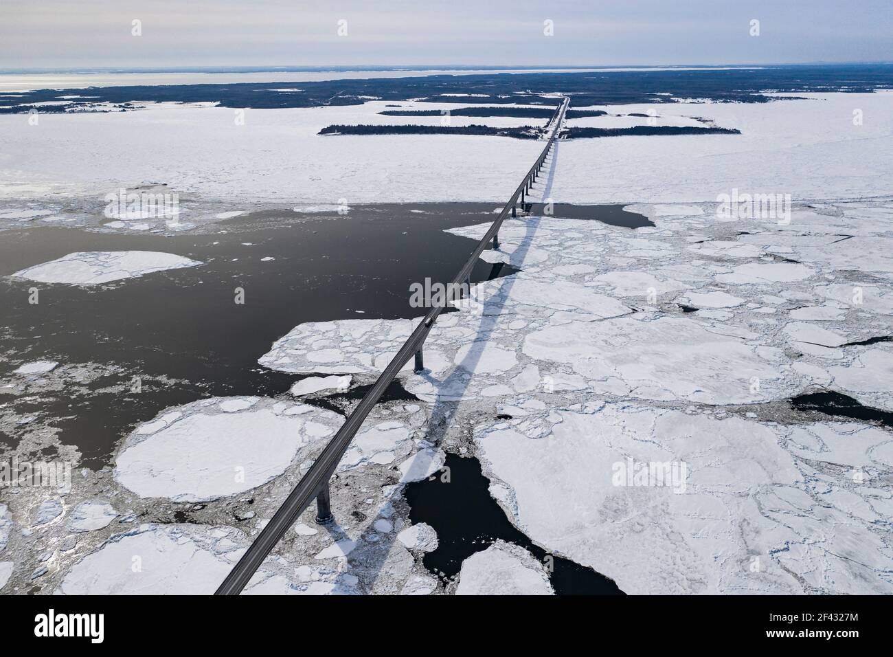 Aerial over Long Bridge and Ice Filled Bay in Canada Stock Photo
