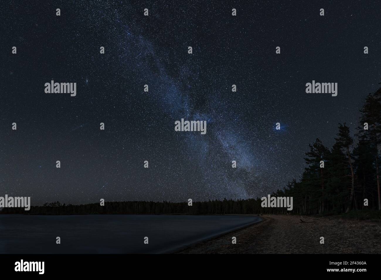An amazing view of the starry sky and the Milky Way over the lake at ...