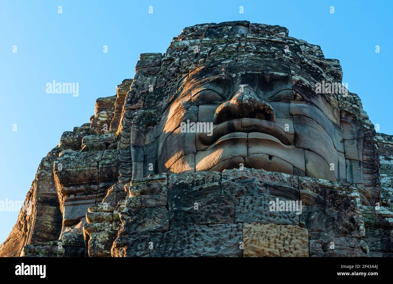 Stone sculpture of a bodhisattva or Buddha face in the Bayon Temple, Angkor Thom, Cambodia. Stock Photo