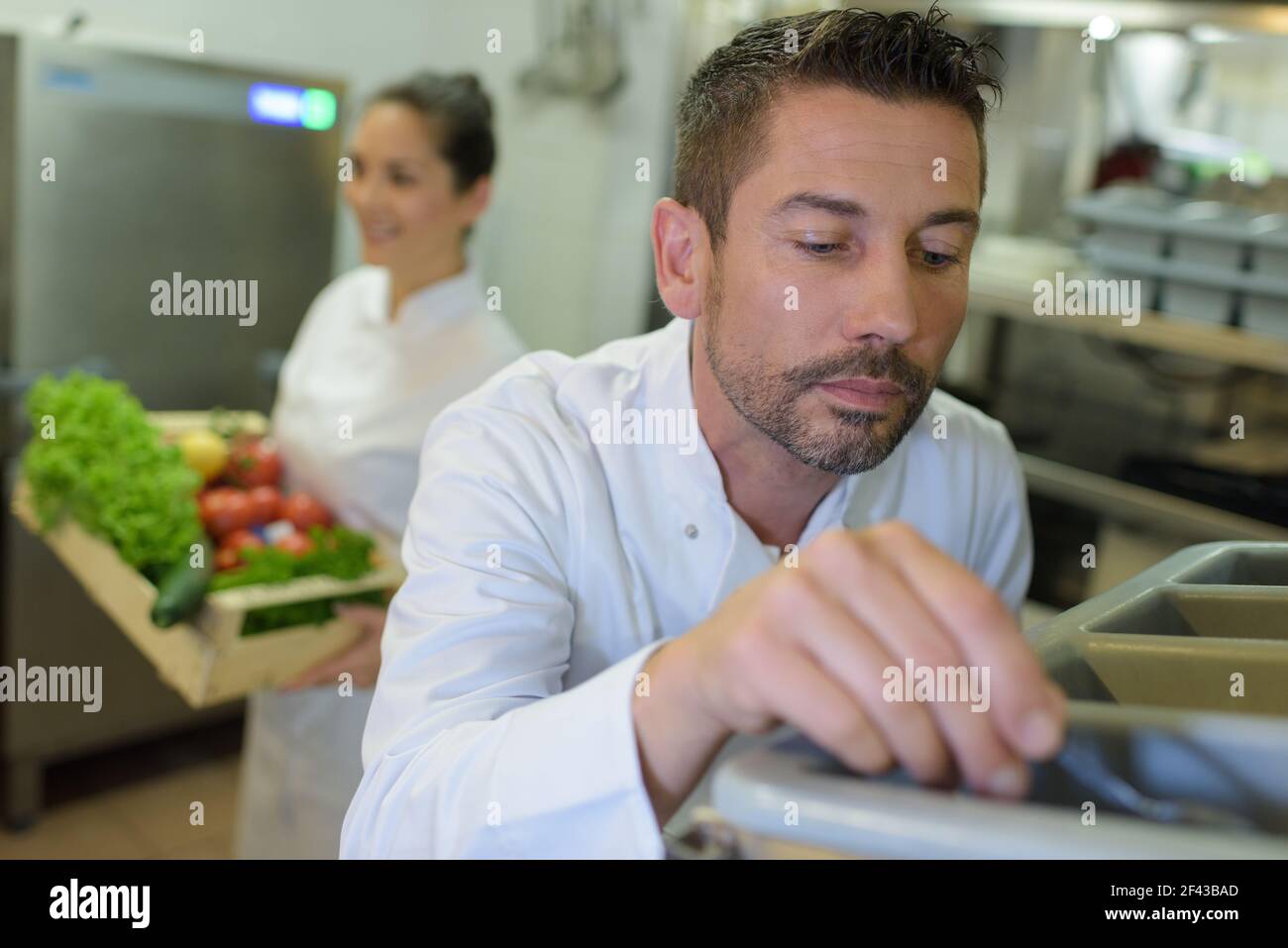 restaurant pantry worker taking cutlery out Stock Photo Alamy
