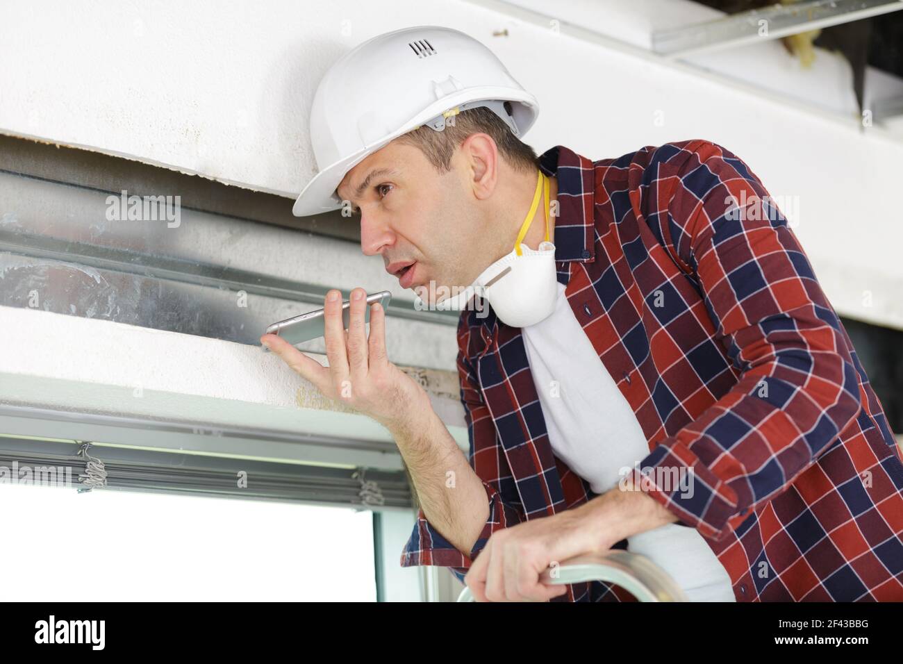 smiling foreman talking on cell phone Stock Photo