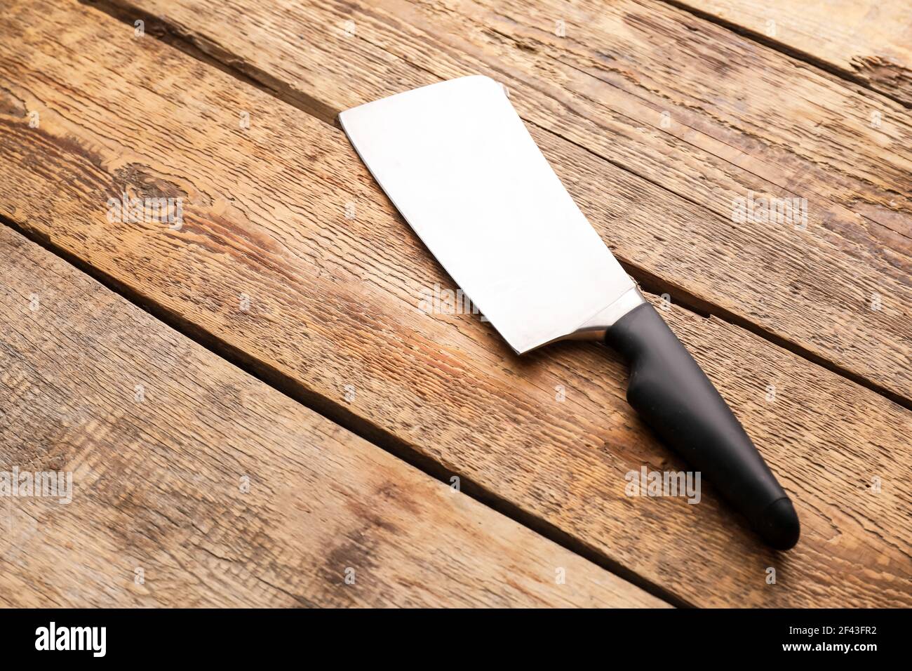 Knife with black handle on wooden background Stock Photo