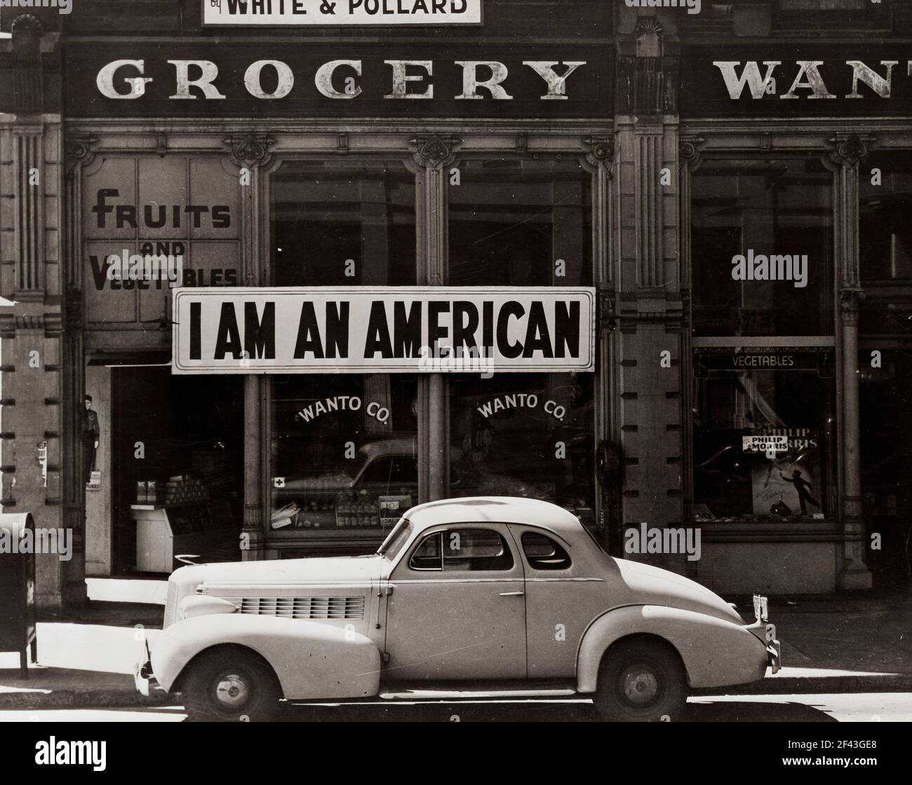 Wanto Co. store located at 401 - 403 Eighth and Franklin Streets in Oakland, California. The business was owned by the Matsuda family. Tatsuro Matsuda, a University of California graduate, commissioned and installed the 'I am an American' sign.Photograph by Dorothea Lange. Stock Photo