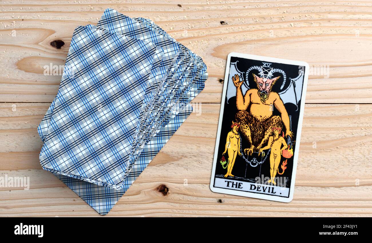 The devil Tarot cards , Tarot cards on wooden background . Stock Photo