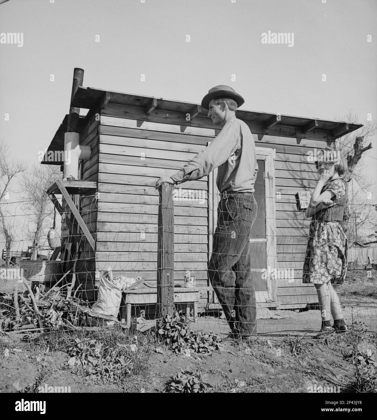 Madera County, family from near Dallas, Texas. Rent is five dollars a month. 'There's no future here. I've been following the work (migratory labor) but there's no chance for a fellow to get a holt hisself in this country. The last job I had is tractor driving for thirty-five cents an hour. Had that job for five months until a Filipino comes along for twenty-five cents an hour. I was raised on a cotton farm my father owned a little place back there and I'm plumb willing to leave this country for good before I get too old, If I could get the chance to farm.. February 1939. Photo: Dorothea Lange Stock Photo