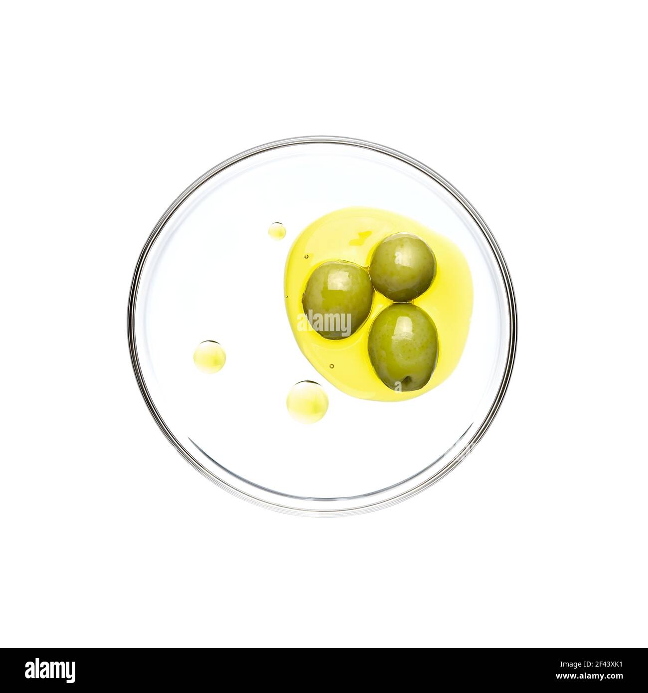 Green olive and oil on petri dish over white background Stock Photo Alamy