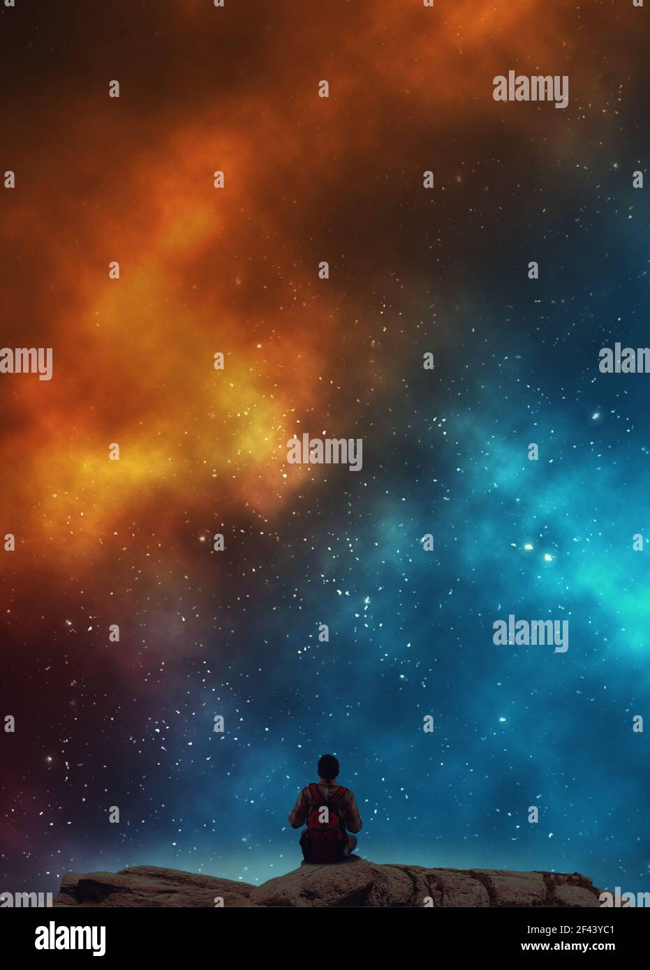 Young man with a backpack looking at colorful nebula . Stock Photo