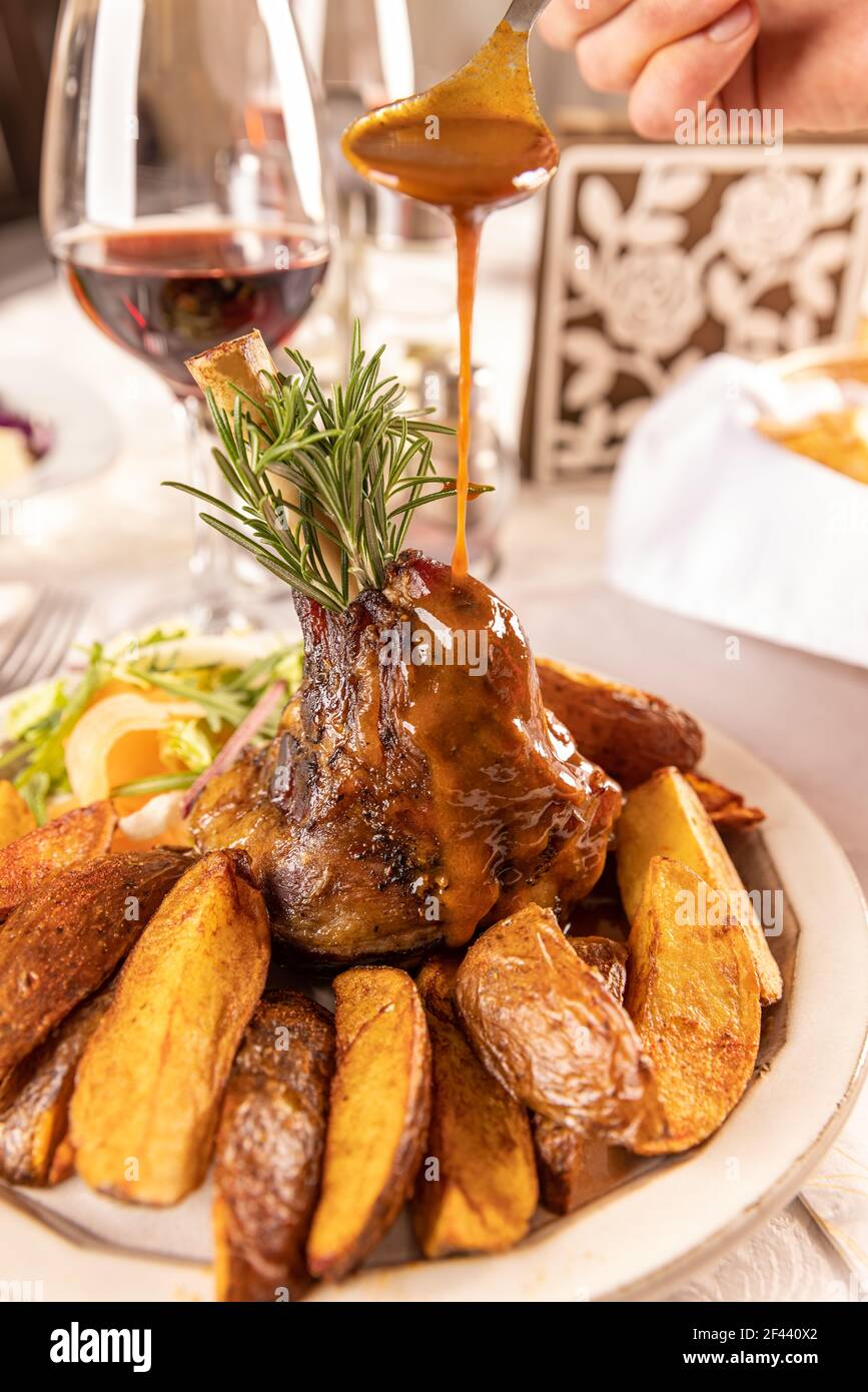 Slow cooked lamb shanks served with red wine sauce Stock Photo Alamy