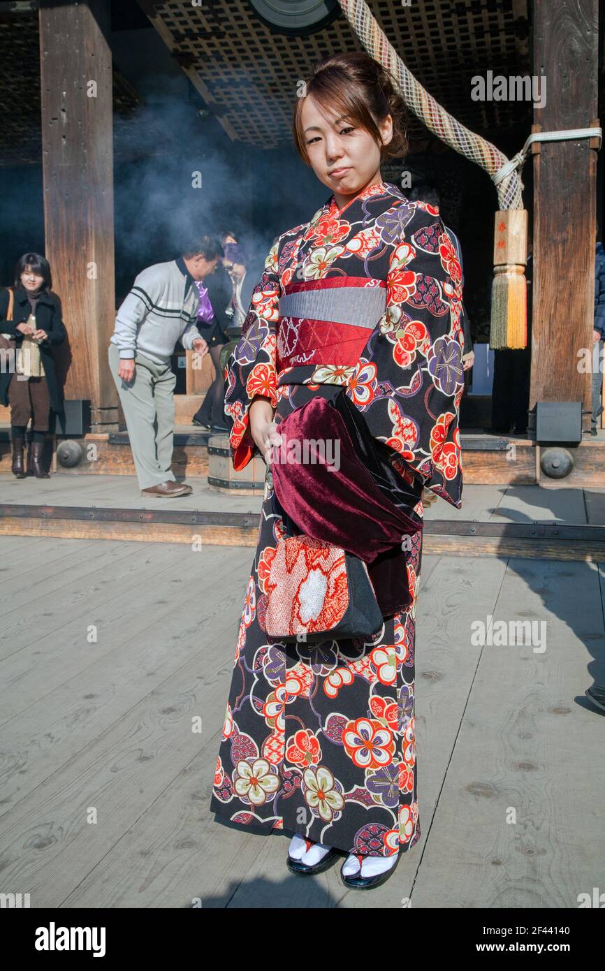 Young Japanese female wearing kimono poses at Kiyomizu-dera Temple