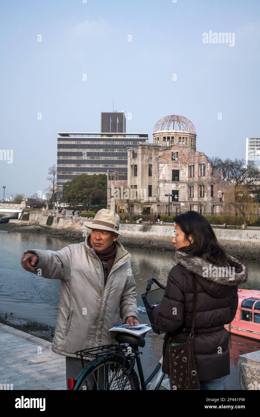 Japanese survivor from the August 1945 Atomic Bomb talks in front of Hiroshima Peace Memorial which remains as a symbol of hope for world peace, Japan Stock Photo