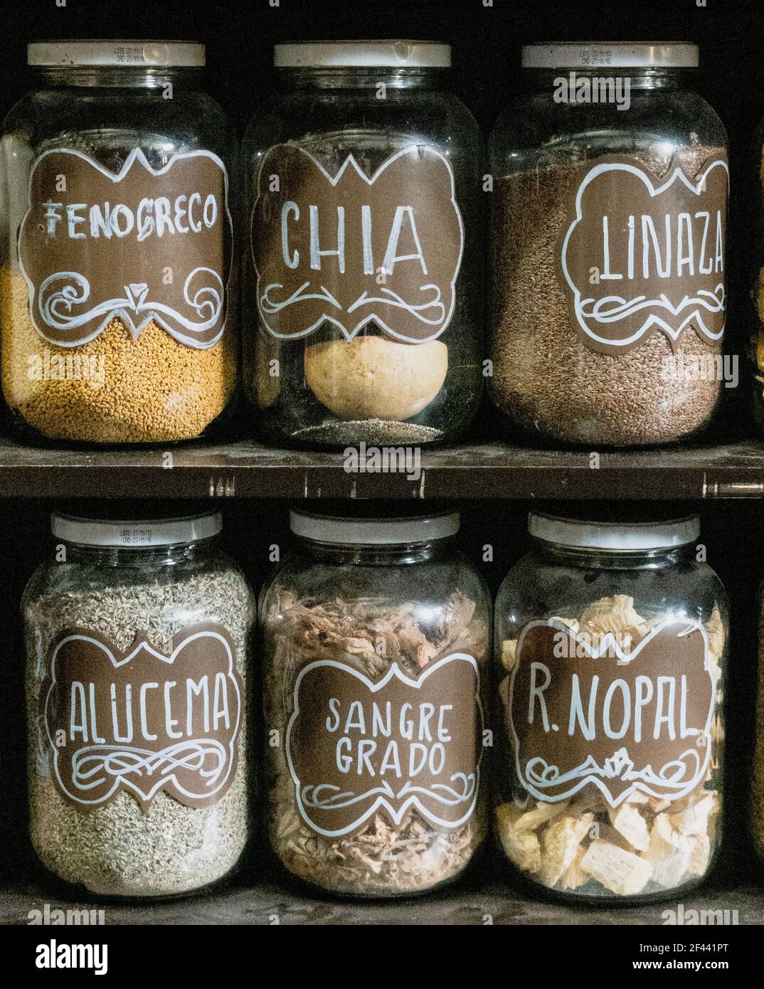 Jars on a store shelf labled with various spices. Stock Photo