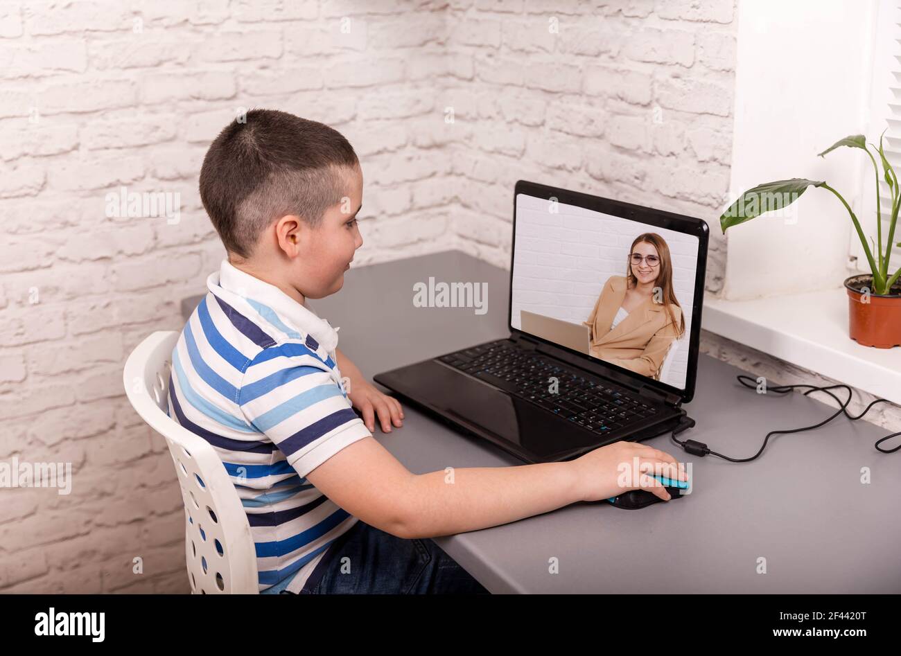 Cute boy taking online courses. Online education and e-learning. Stock Photo