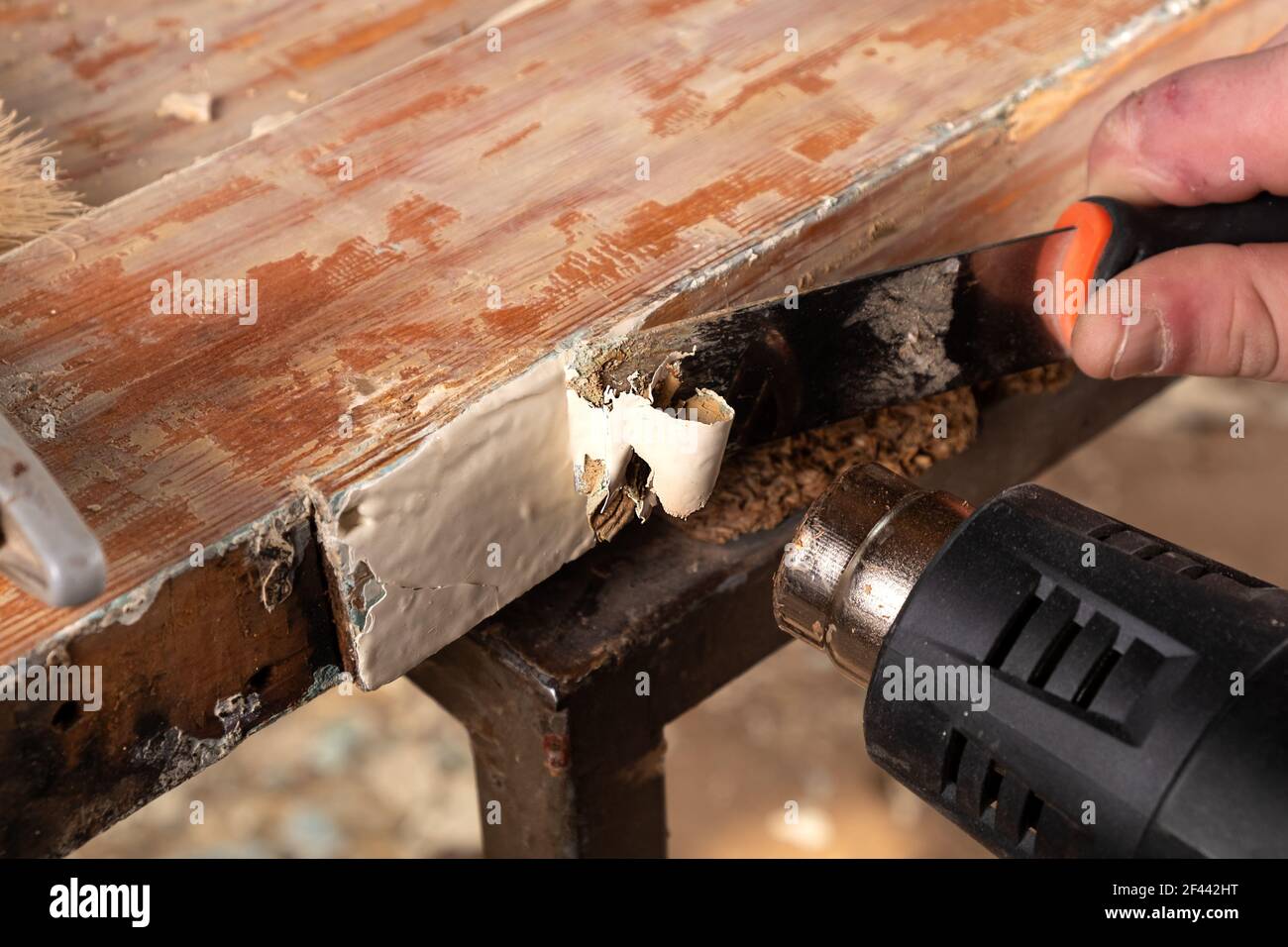 removing old paint from old wooden doors with a spatula and a heat gun
