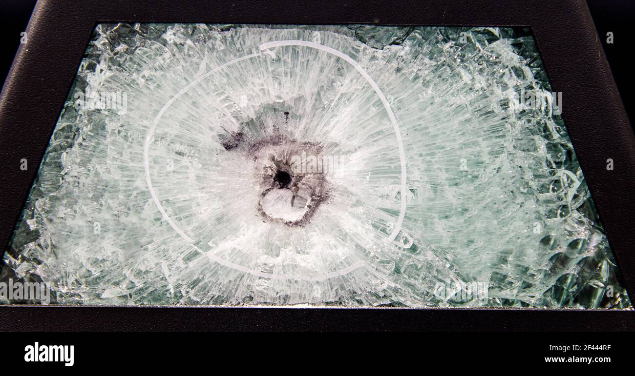 broken glass. Armored glass after impact. glass reinforced with a film after being hit by a bullet. Stock Photo