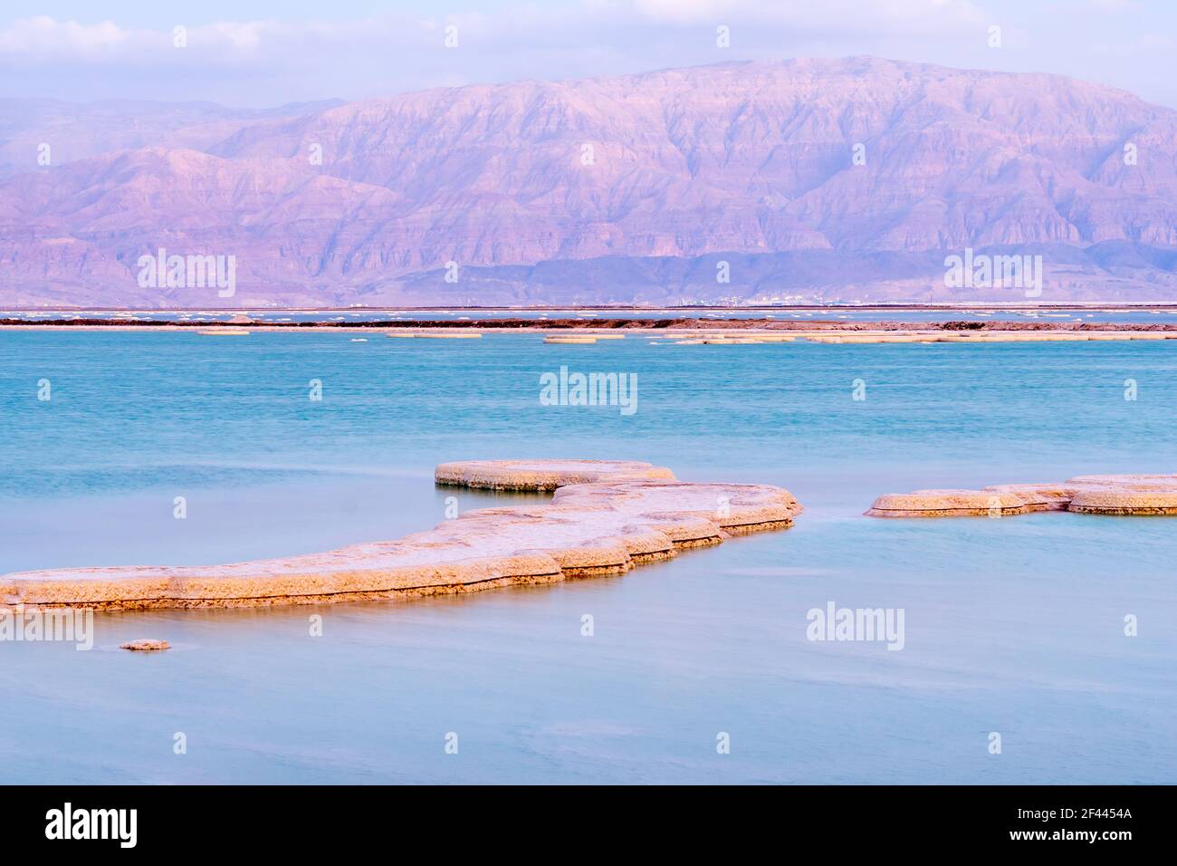 Sunset view of salt formations in the Dead Sea, with the Edom Mountains in the background. Southern Israel Stock Photo