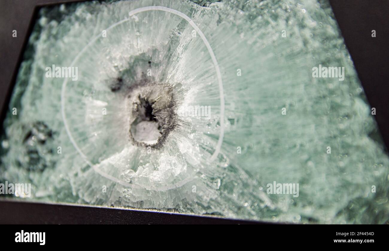 broken glass. Armored glass after impact. glass reinforced with a film after being hit by a bullet. Stock Photo
