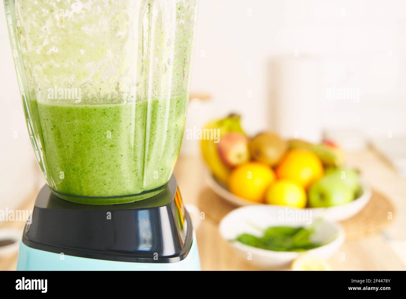 Whiping mixture of berries, fruits and vegetables in blender. Preparing