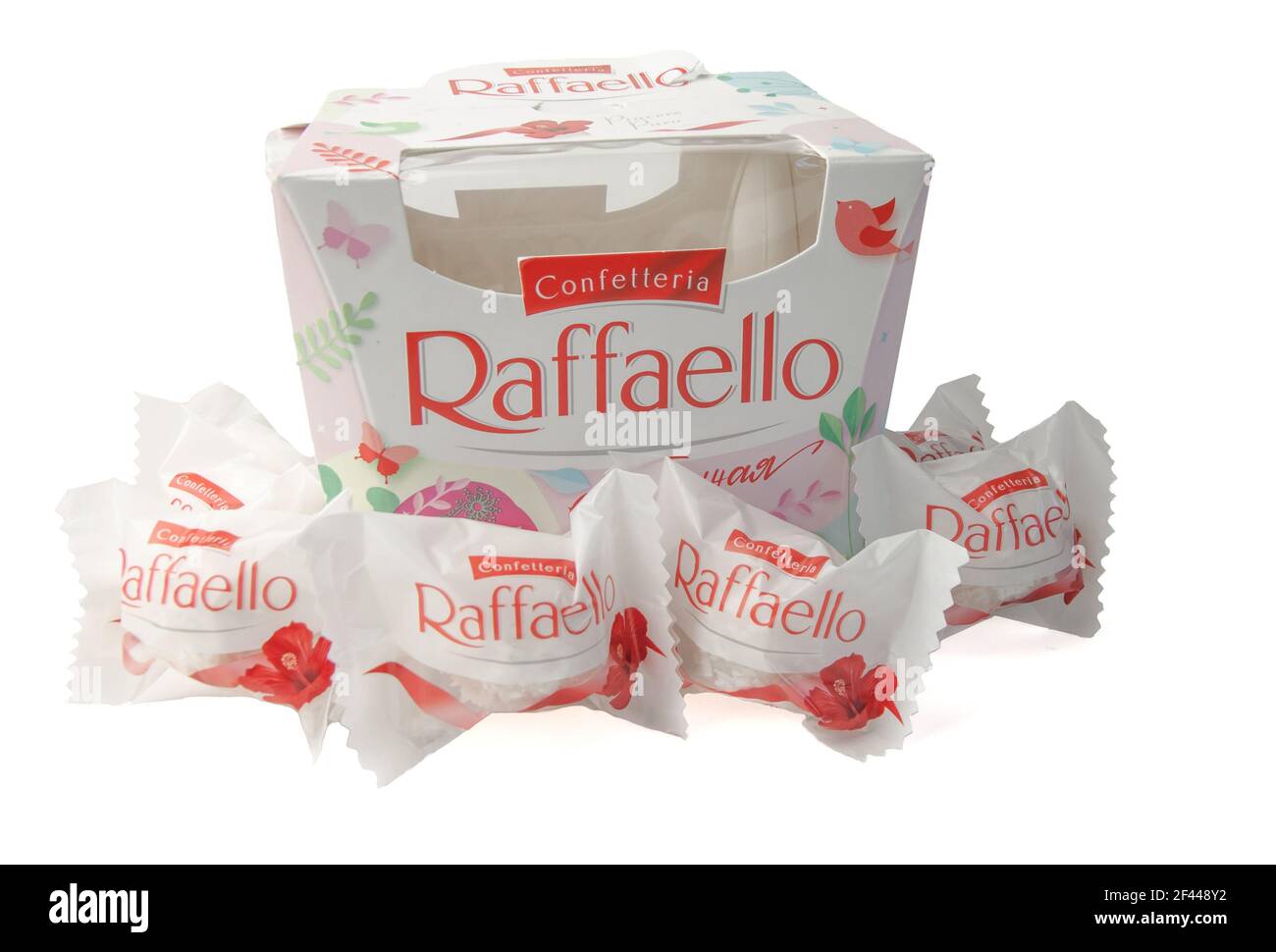 Krasnodar, Russia - March 9, 2021: A box of Raffaello spring collection with candy scattered in front of it in a package isolated on a white backgroun Stock Photo