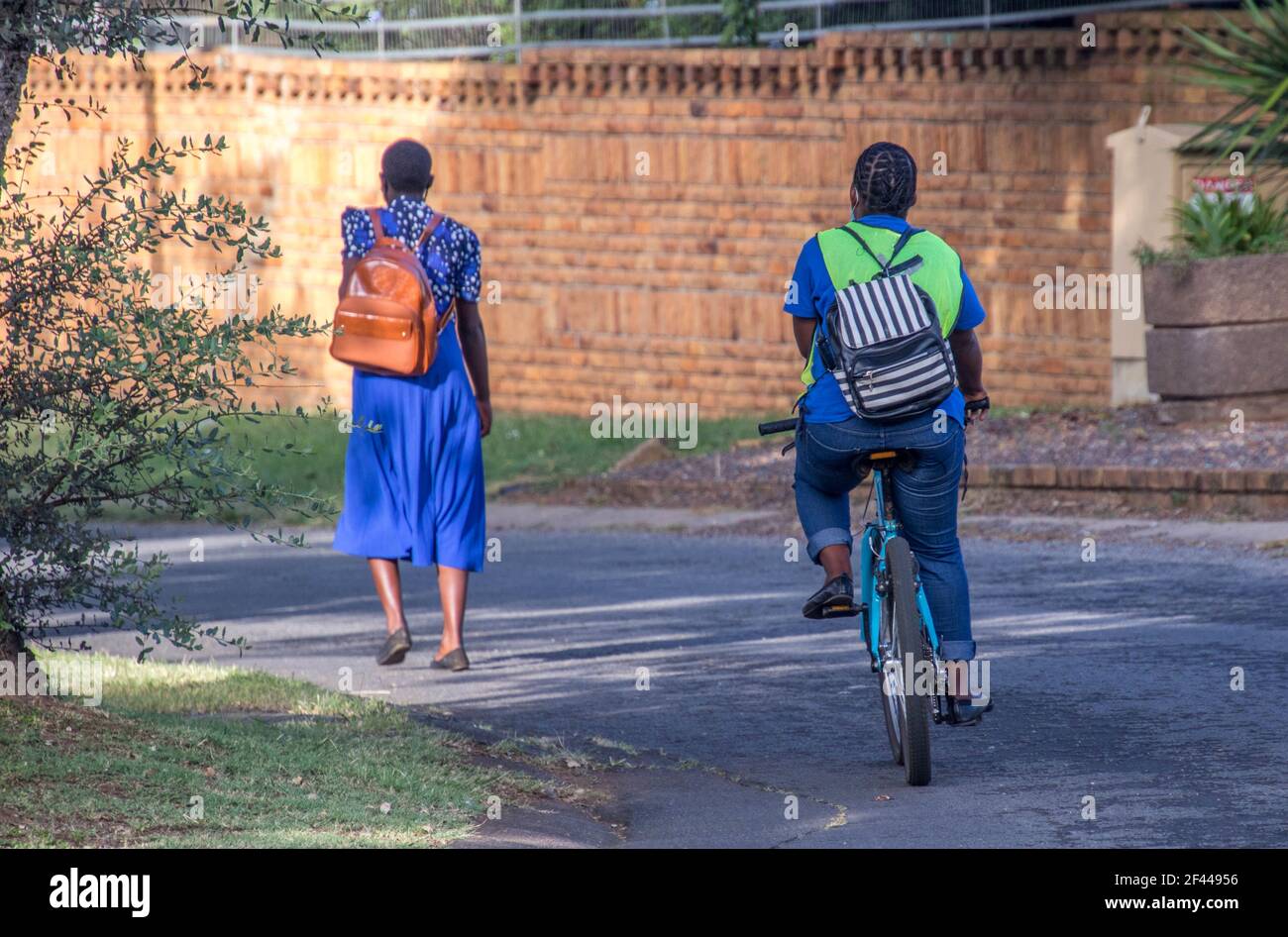 Johannesburg, South Africa - unidentified black people walk and cycle to work after restrictions are lifted for covid-19 Stock Photo