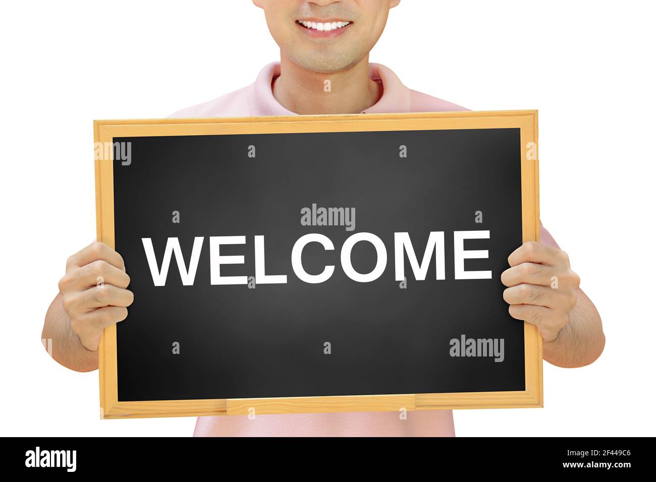 WELCOME sign on blackboard held by smiling man Stock Photo - Alamy