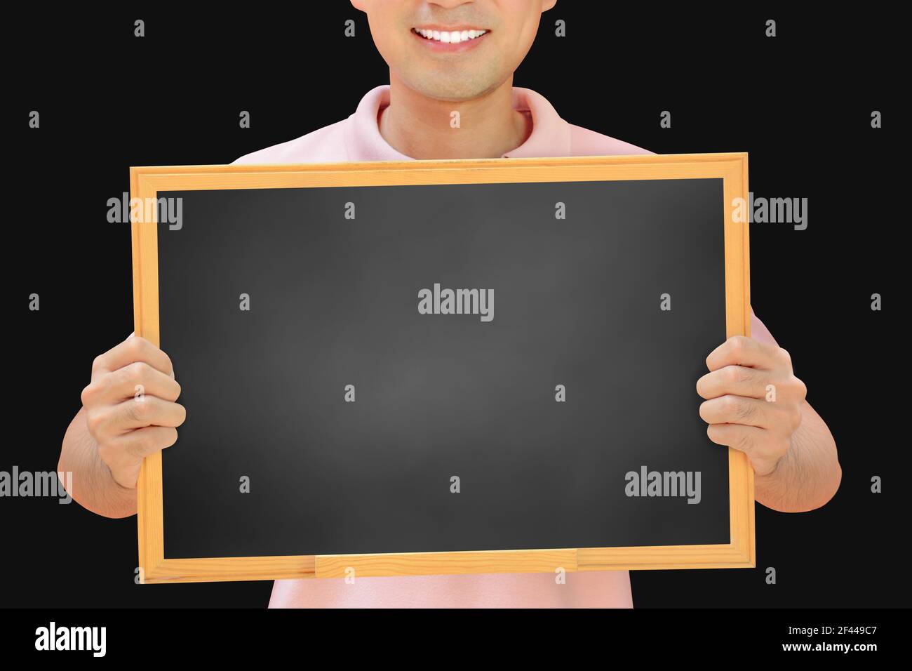 Smiling man holding blank blackboard - can fill your texts & used as placard, notice & advertising boards etc. Stock Photo