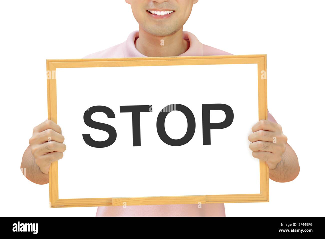 STOP sign on whiteboard held by smiling man Stock Photo
