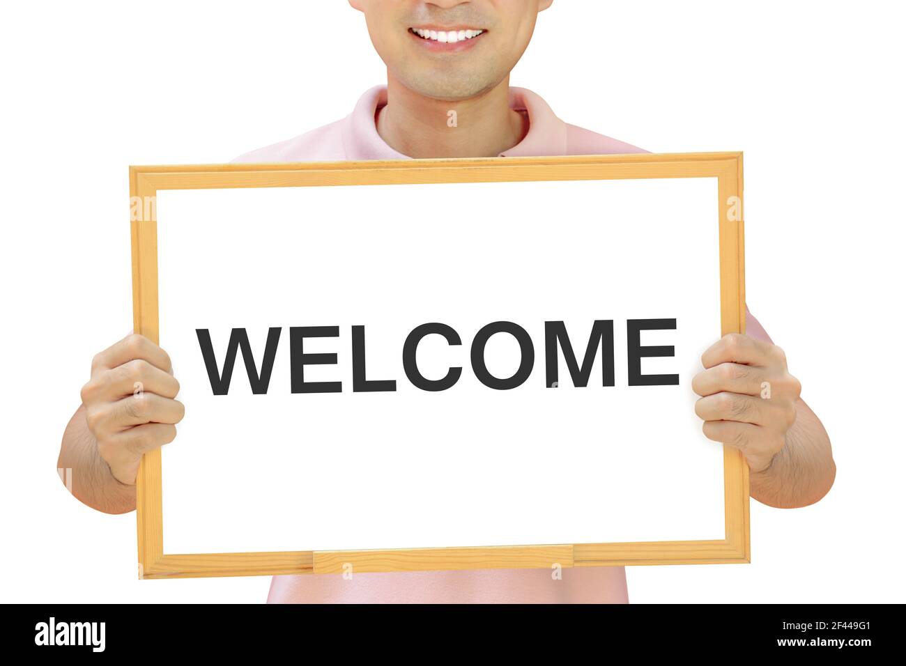 WELCOME sign on whiteboard held by smiling man Stock Photo