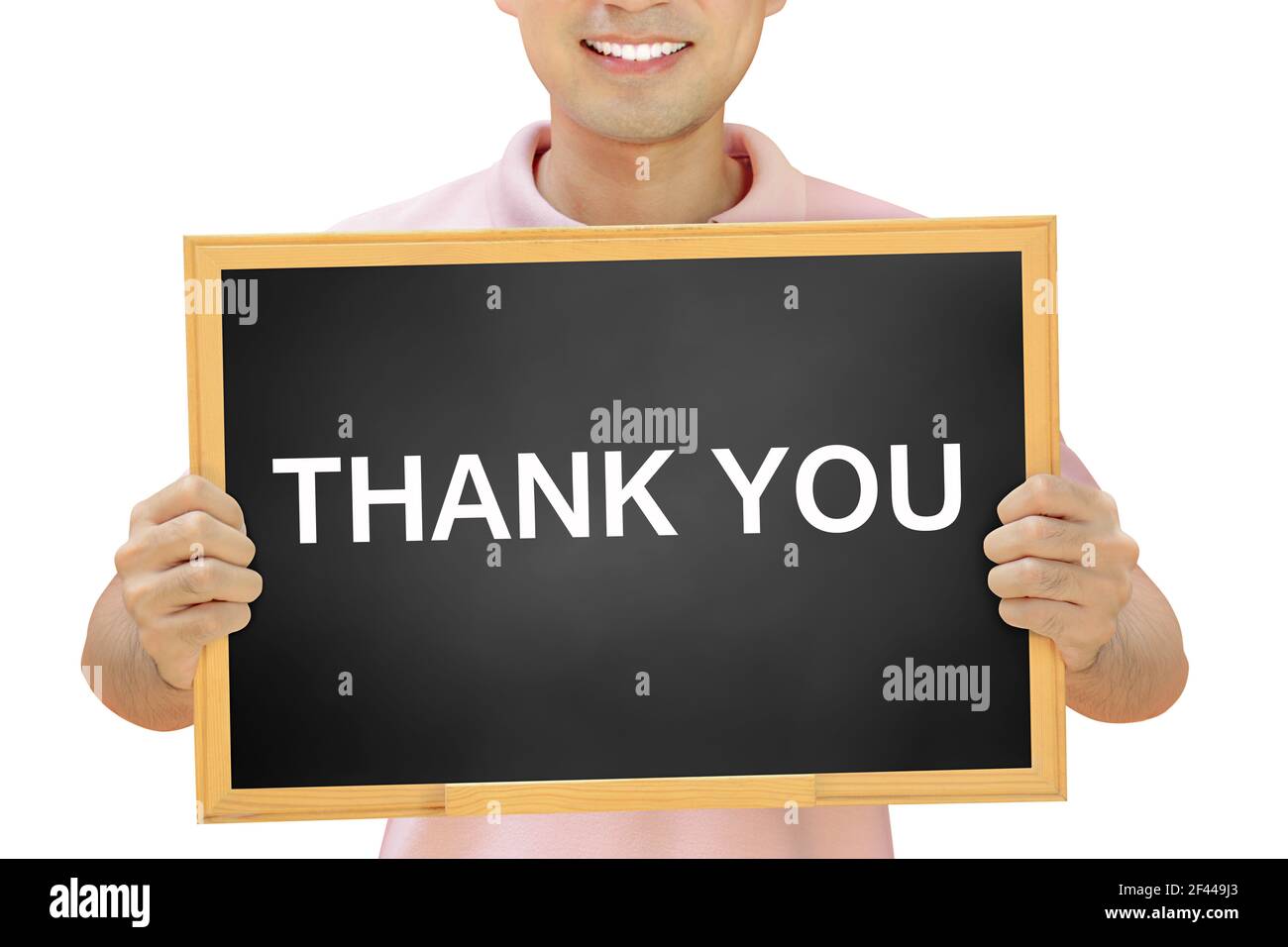 THANK YOU words on blackboard held by smiling man Stock Photo