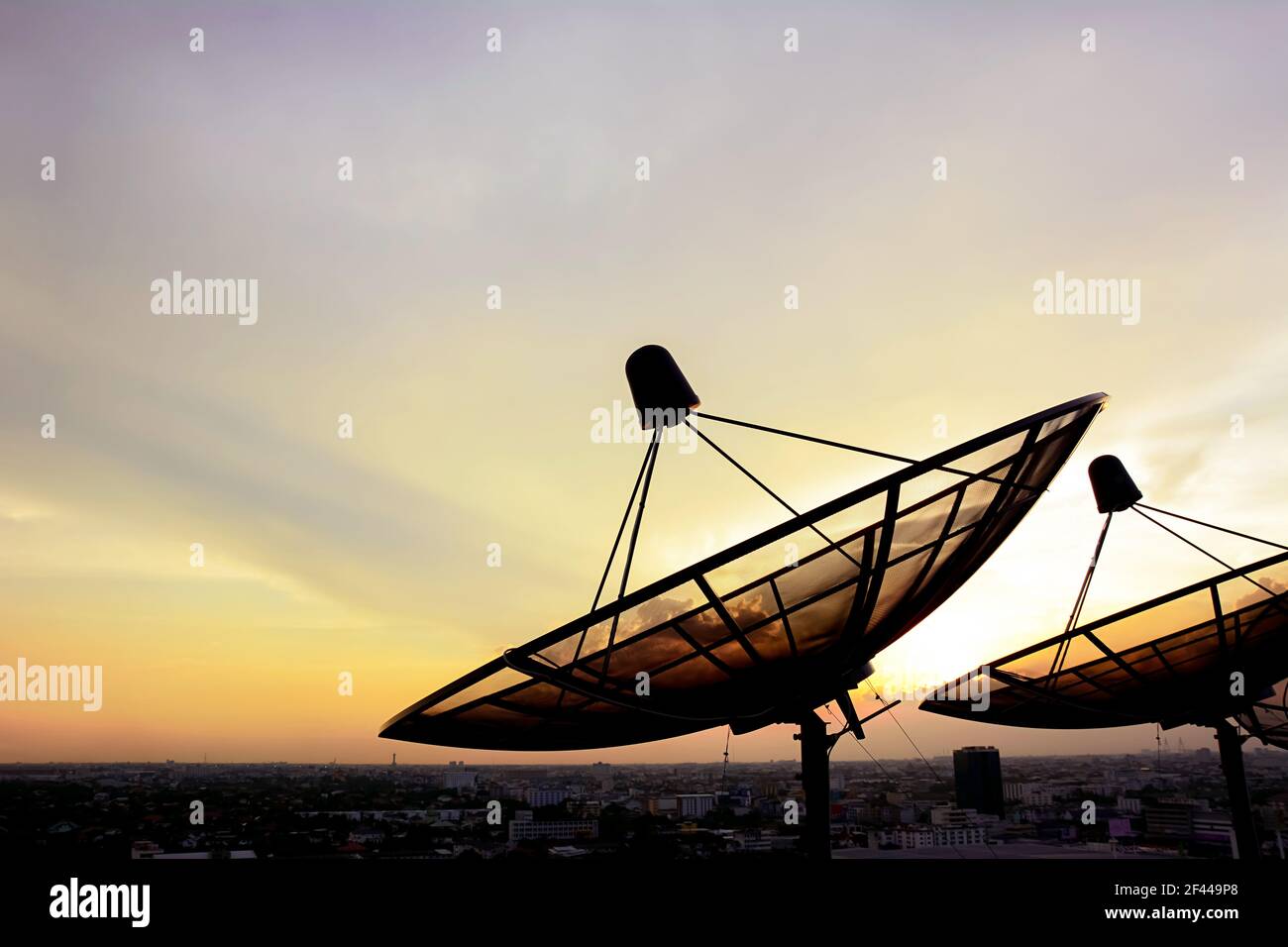 Satellite dishes on twilight sky background Stock Photo