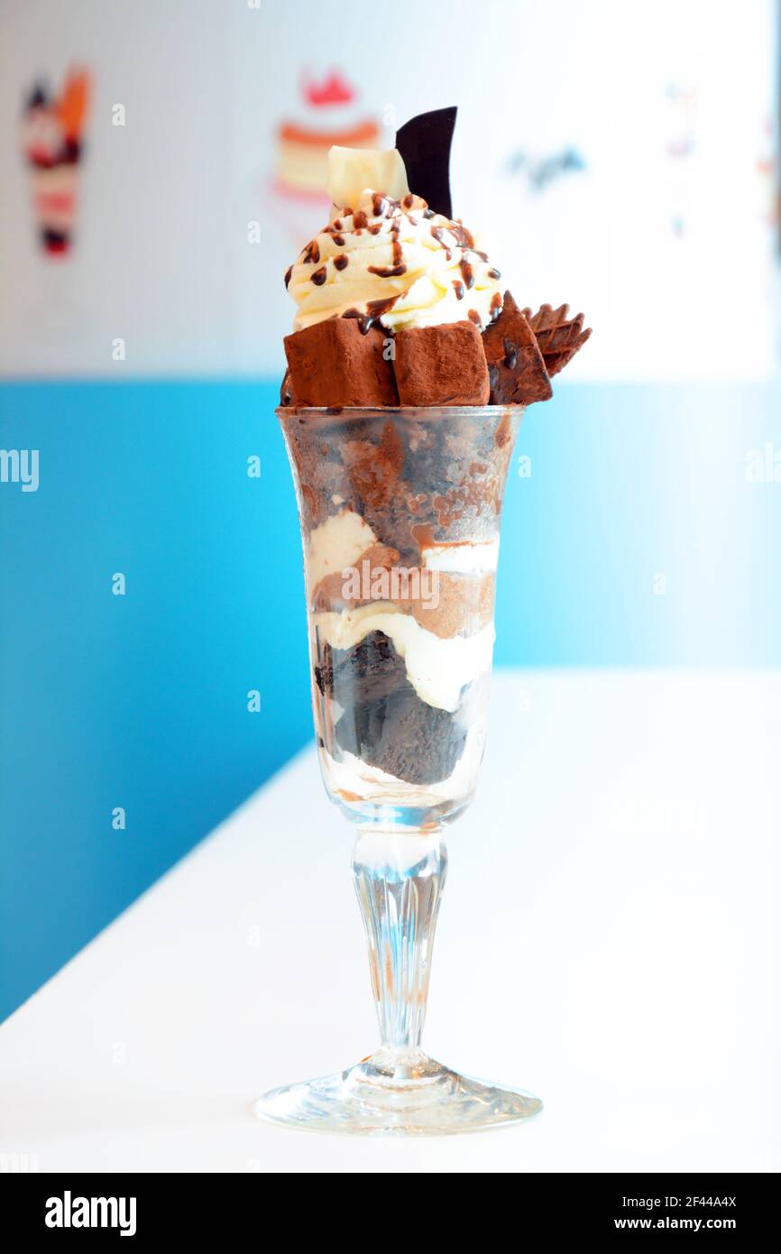 Delicious chocolate ice cream in the glass with small chocolate bars & whipped cream on top Stock Photo