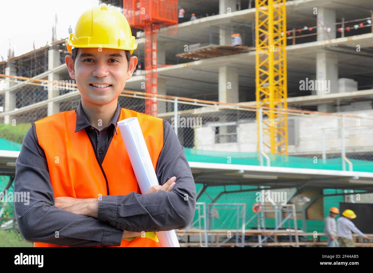 Asian engineer or foreman in front of construction site Stock Photo