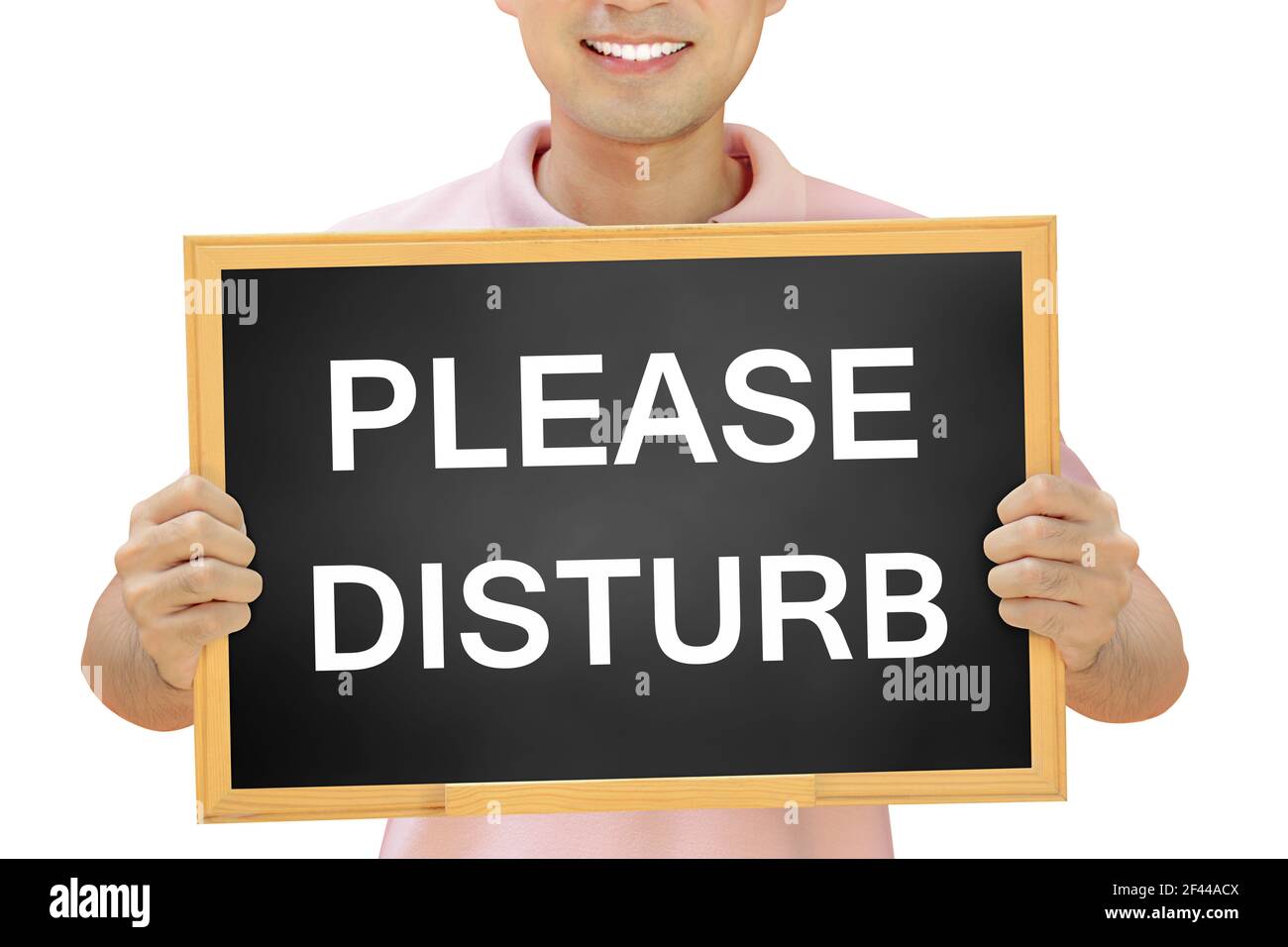 PLEASE DISTURB sign on blackboard held by smiling man - customer service concept Stock Photo