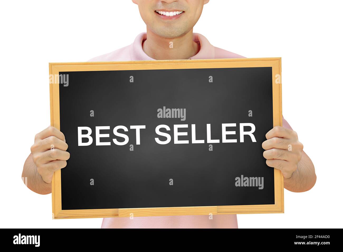 BEST SELLER sign on blackboard held by smiling man Stock Photo