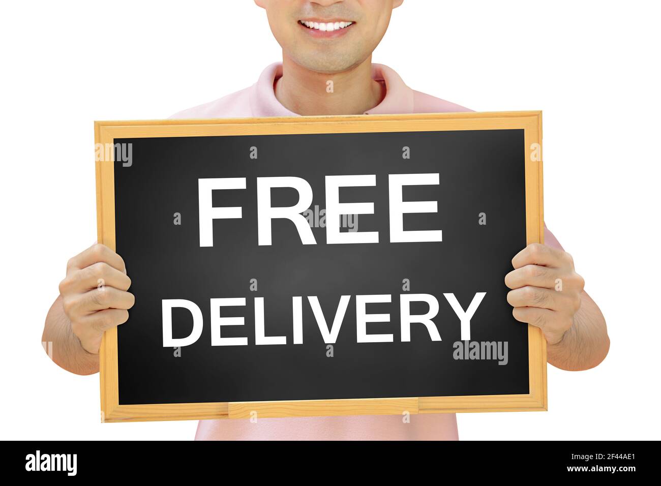 Free delivery sign on blackboard held by smiling man Stock Photo