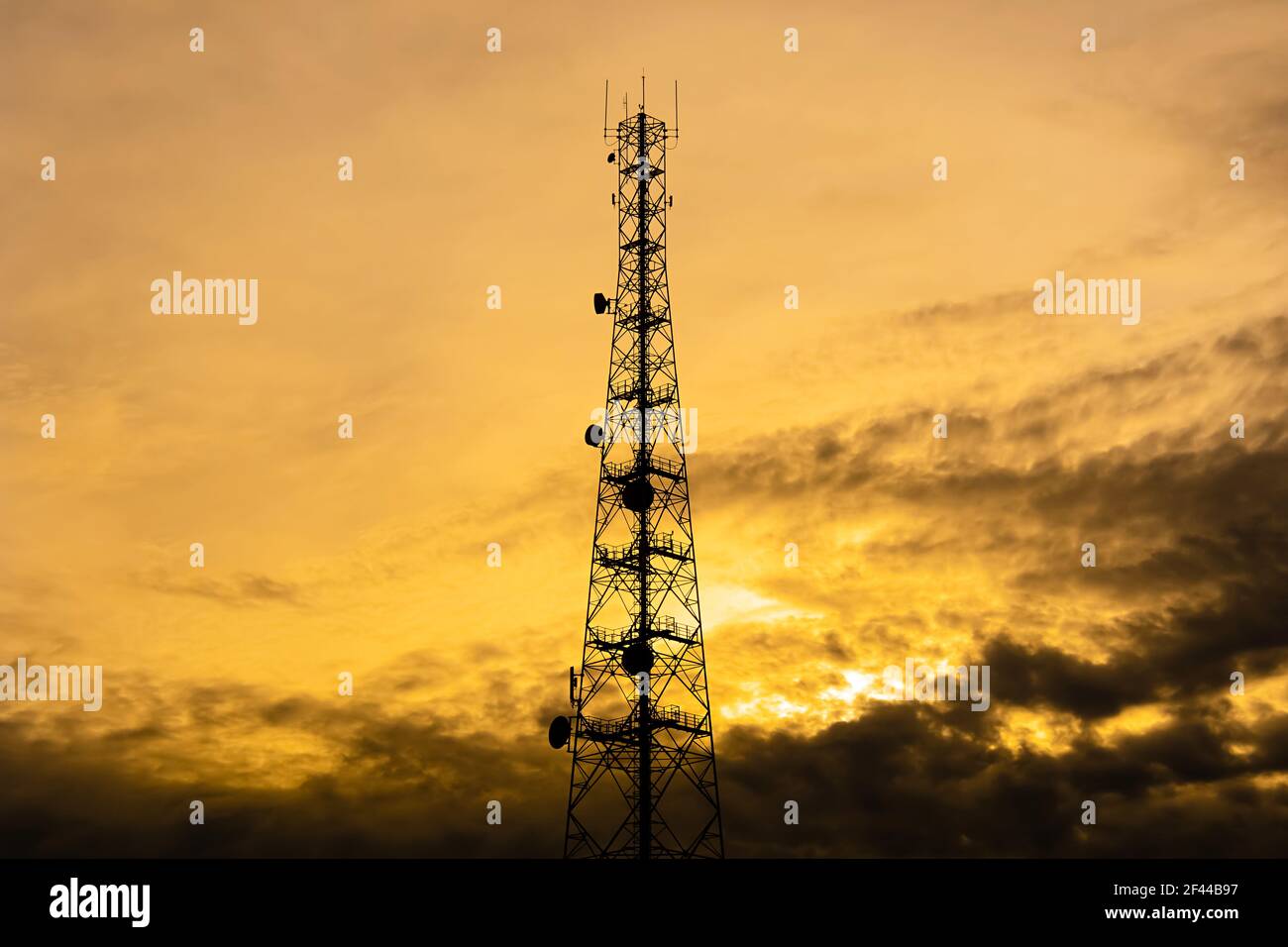 Telecom tower silhouette  in twilight sky background Stock Photo