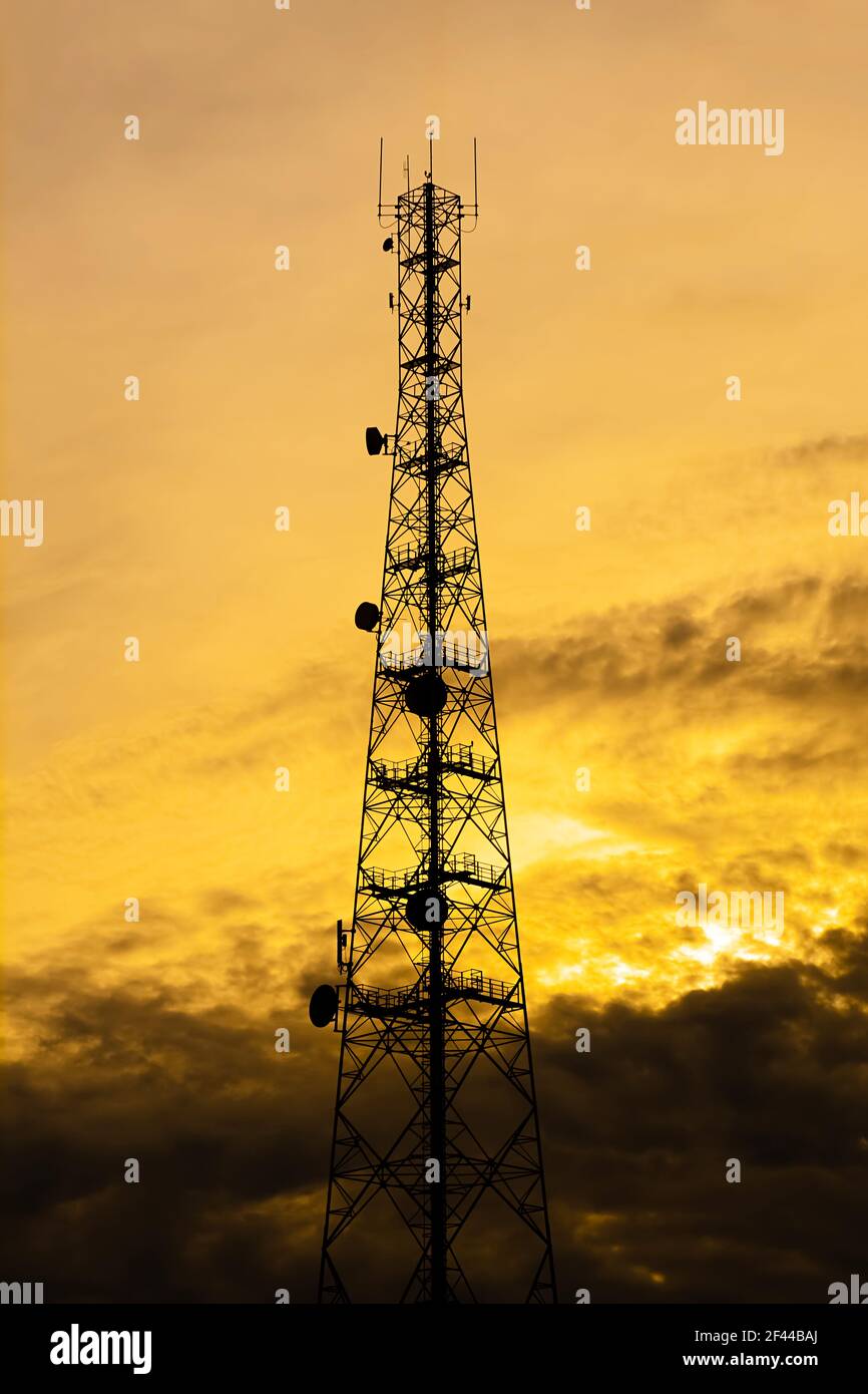 Telecom tower silhouette  in twilight sky background Stock Photo